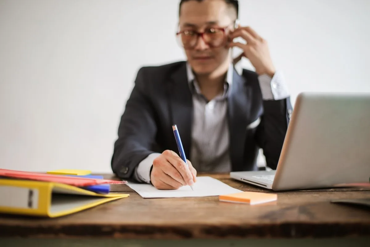 Agent prenant des notes au téléphone